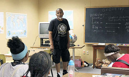 Victor Gibson teaches math to middle schoolers at the Dexter-Elmhurst Center. The retired teacher signed up to work for the Detroit Independent Freedom School Movement. Photo by Zenobia Jeffries.